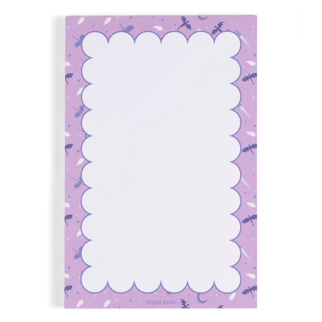 Notepad with purple border and white scalloped edge on a white background