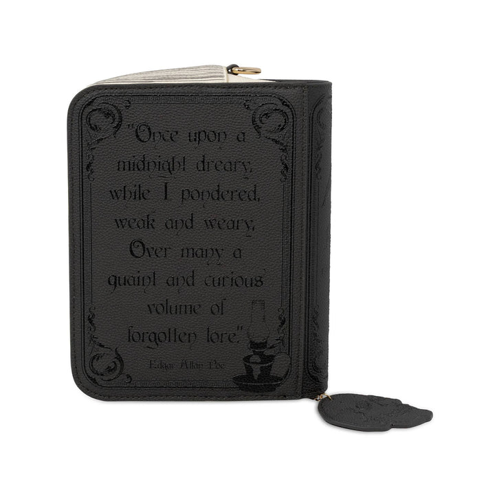 A black zippered wallet styled like a book cover, featuring an embossed quote from Edgar Allan Poe&