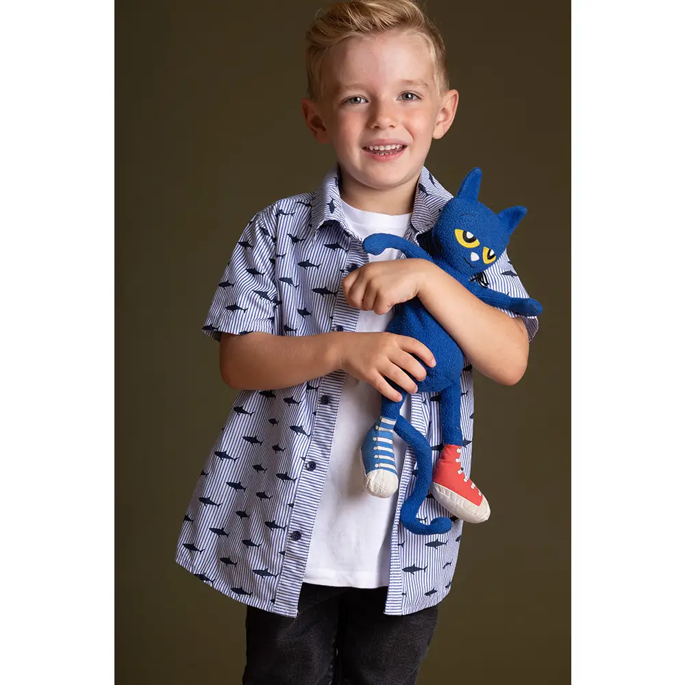 Child holding a blue plush toy against a brown background