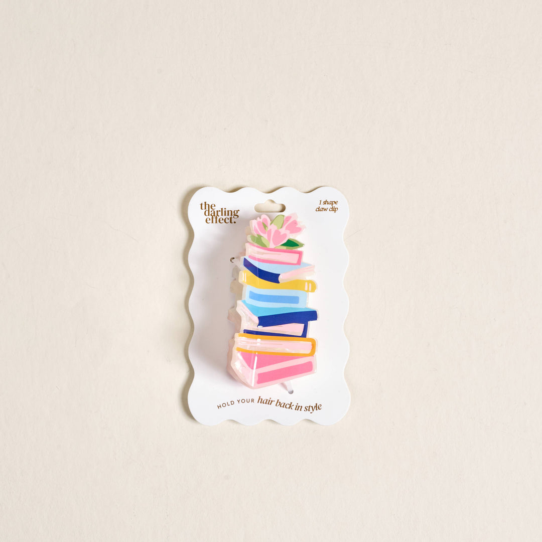 Colorful hair clip on a branded card against a beige background