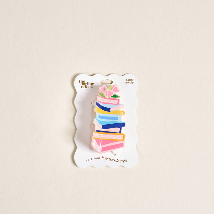 Colorful hair clip on a branded card against a beige background
