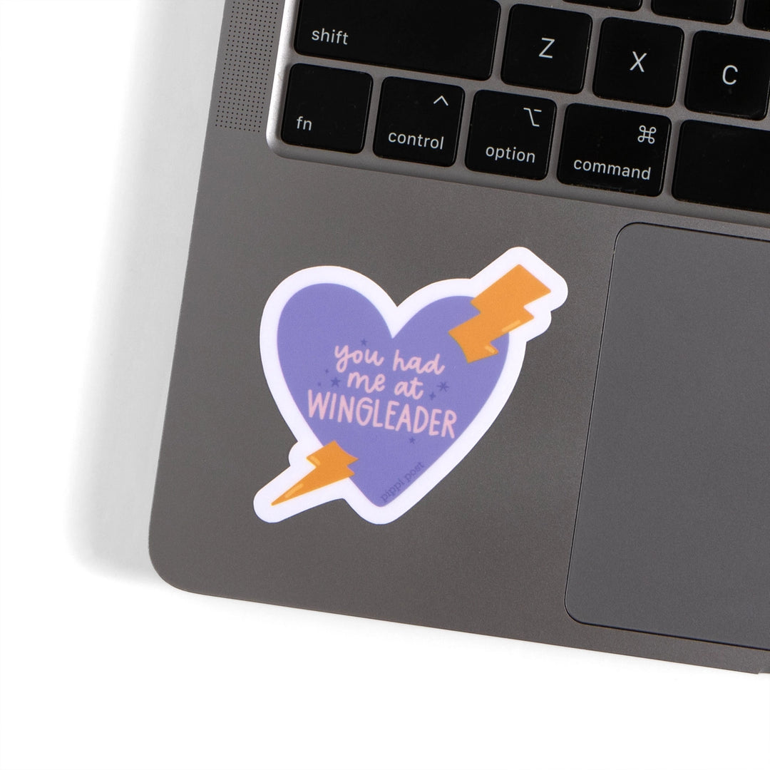 Laptop with a heart-shaped sticker reading &