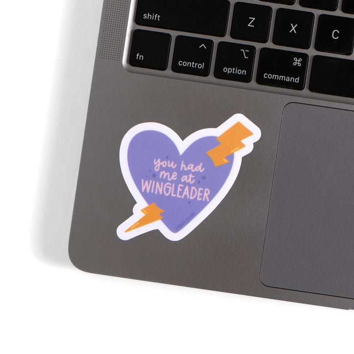 Laptop with a heart-shaped sticker reading &
