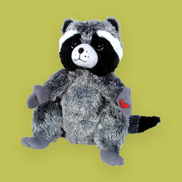 Plush raccoon toy with a heart on a green background