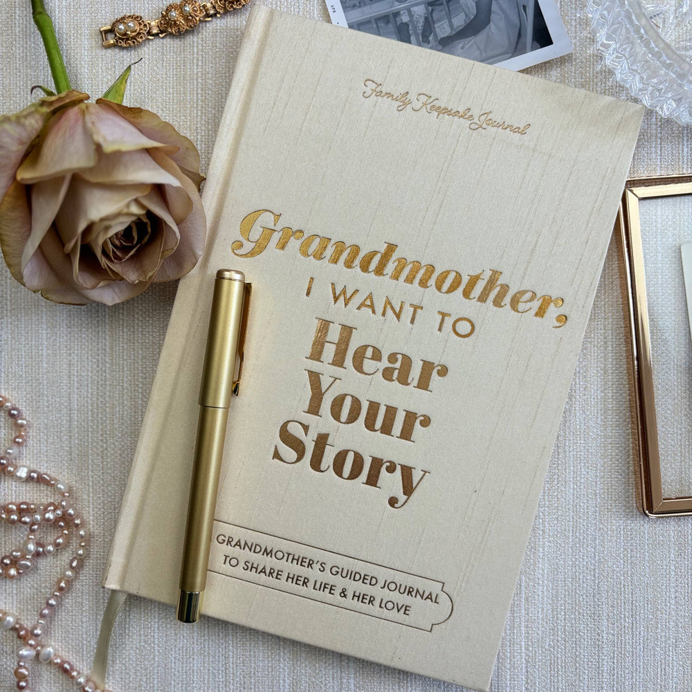 Journal titled 'Grandmother, I Want to Hear Your Story' with a pen on a textured surface.