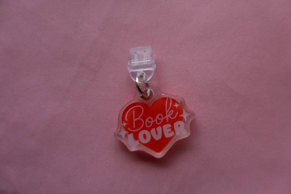 Heart-shaped charm with 'Book Lover' text on a pink background