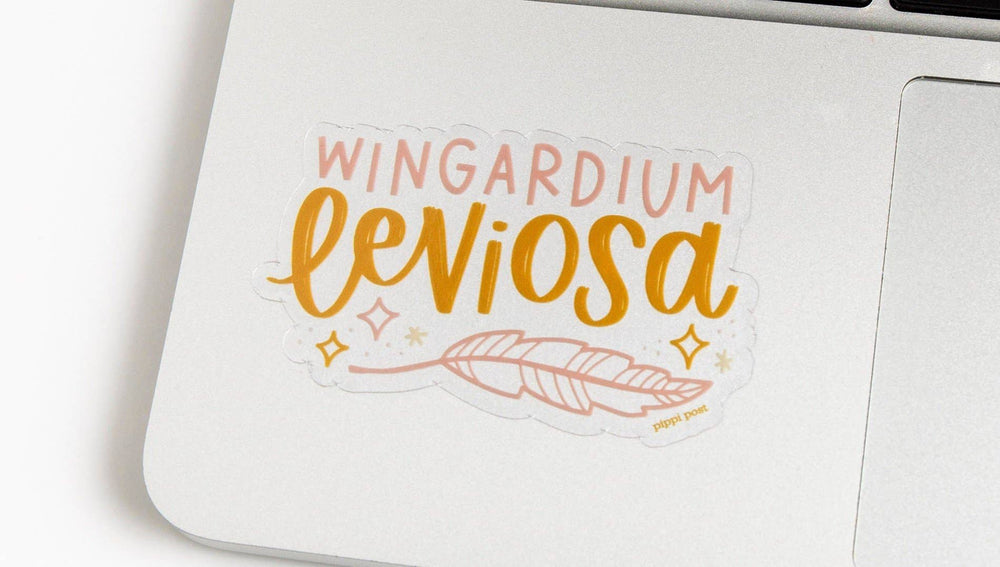 Sticker with 'Wingardium Leviosa' text on a white surface