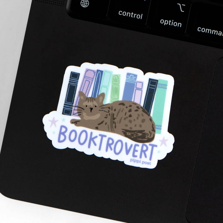 Sticker of a cat with books and &