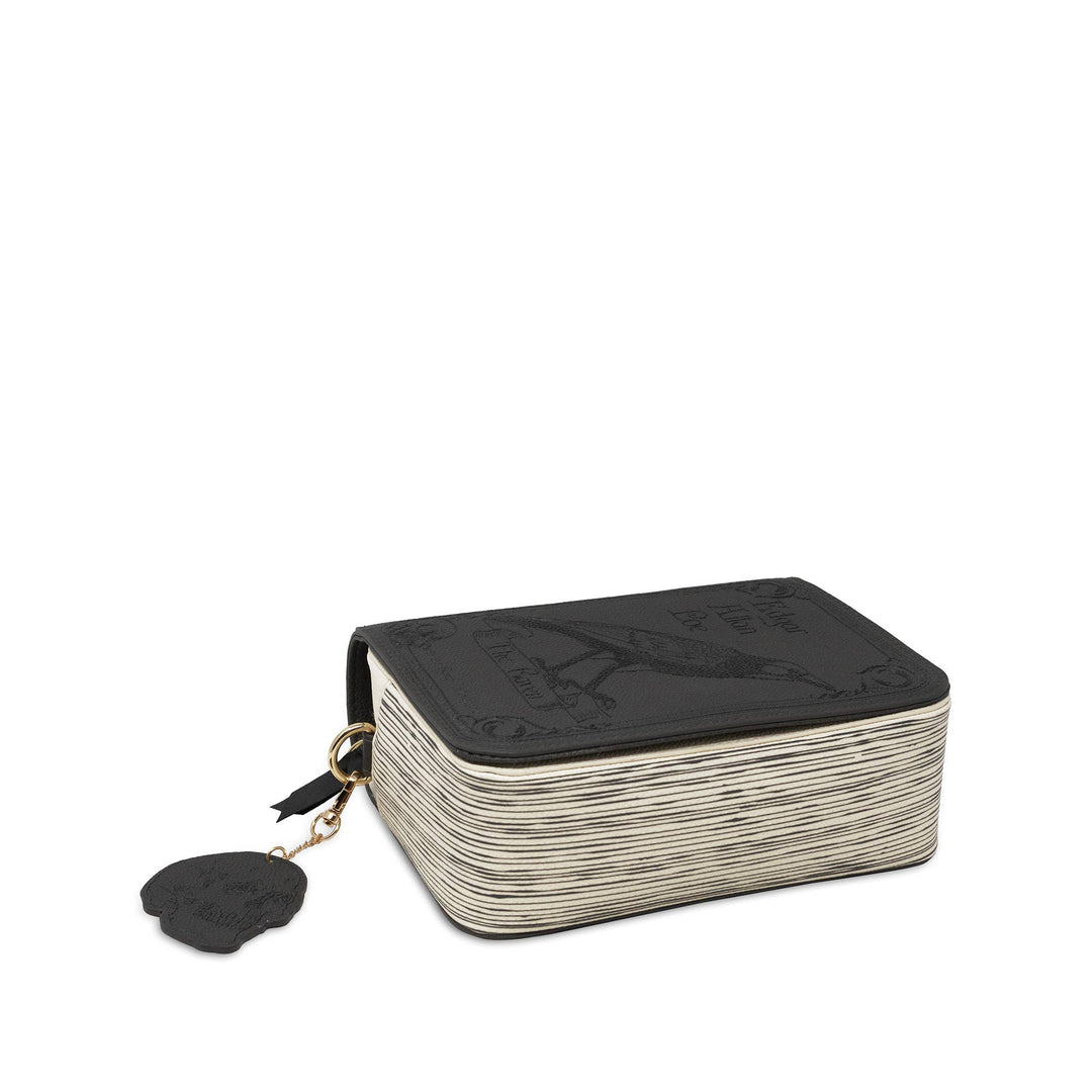 A rectangular black leather zippered pouch with a textured, woven or ribbed off-white side panel and a black skull-shaped zipper pull featuring a gold-tone chain.
