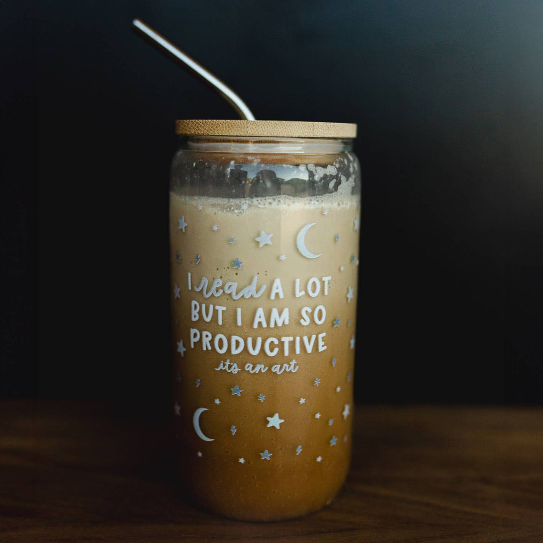 Jar with a straw, filled with a beverage, on a dark background