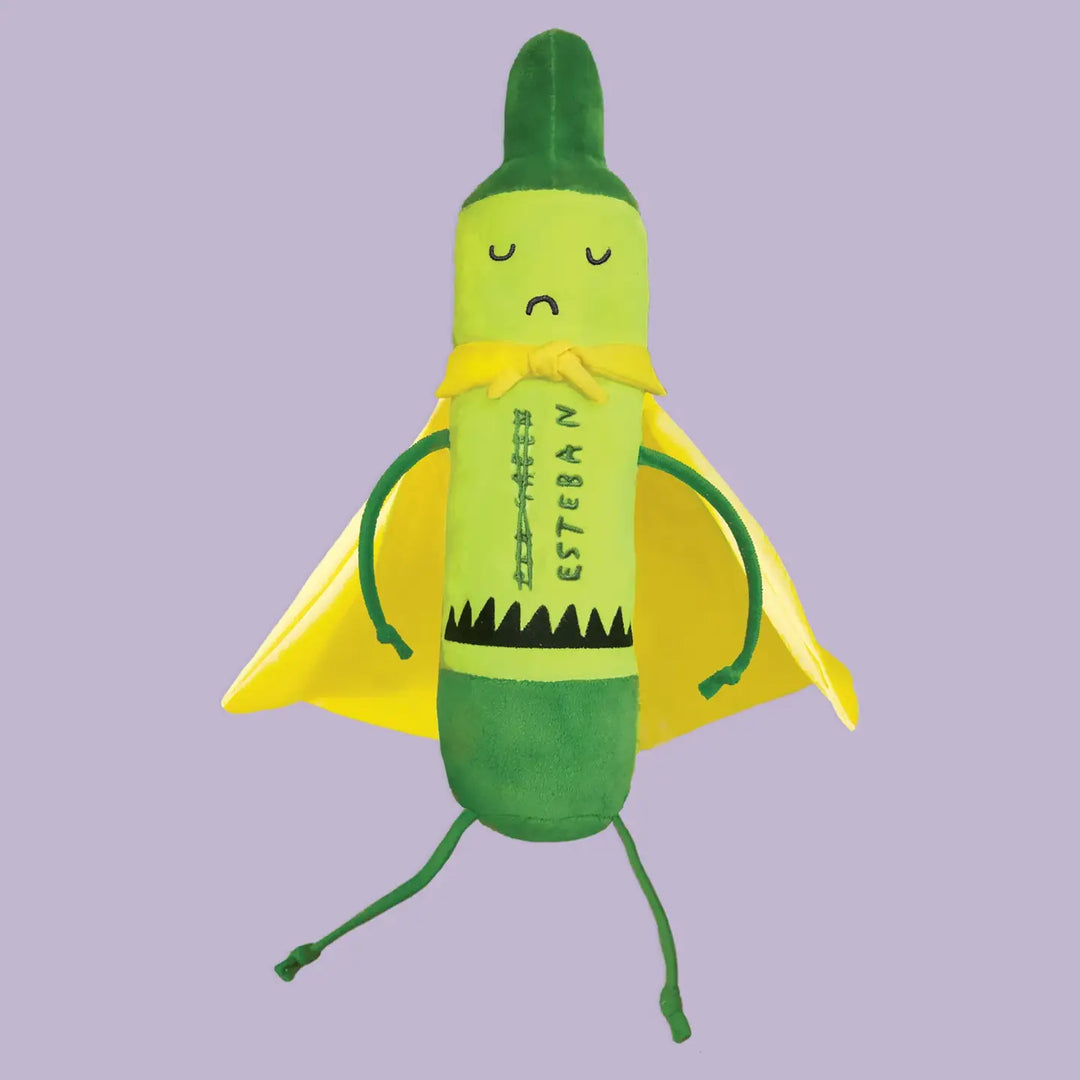 Toy resembling a green crayon with a face on a purple background