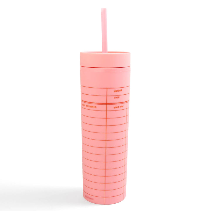 Pink tumbler with a straw on a white background