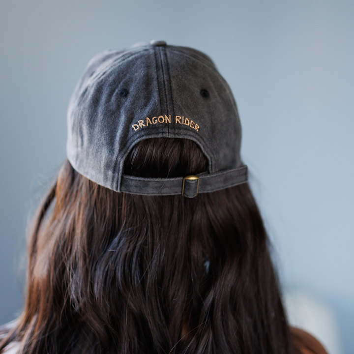 Person wearing a gray cap with &