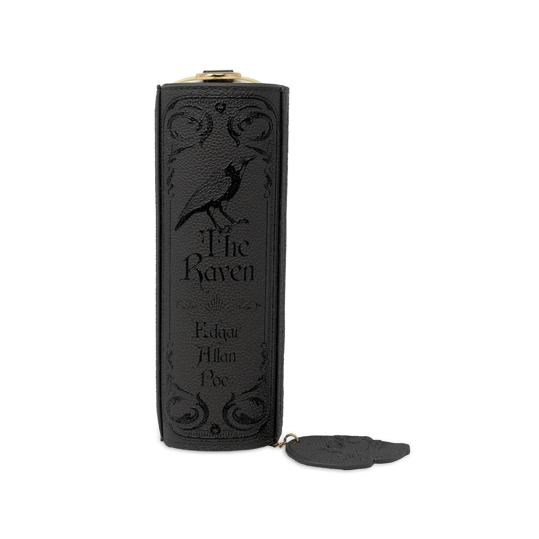 A black leather-like accessory with embossed gothic-style raven artwork and the words &