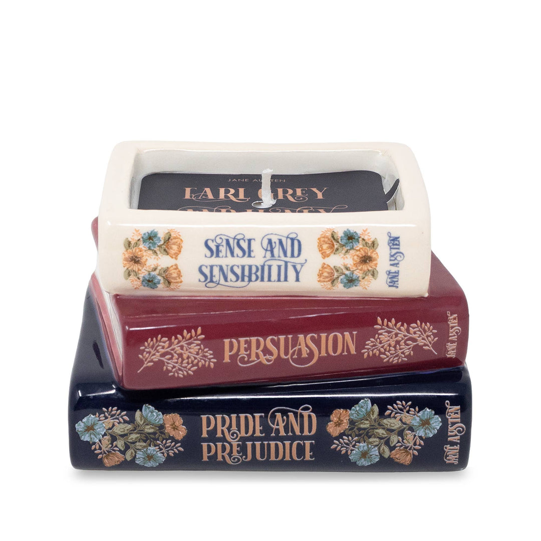 Jane Austen bookstack candle with floral book spines and an Earl Grey and Honey label visible around the wick.