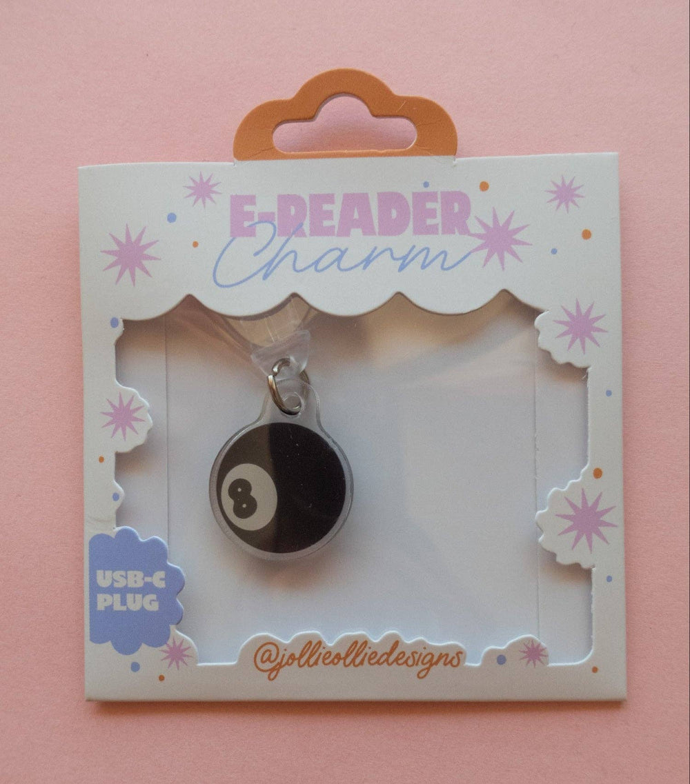 A USB-C charging cable charm shaped like an 8-ball game piece, presented on a decorative white card labeled 'E-READER Charm' with a pink background.