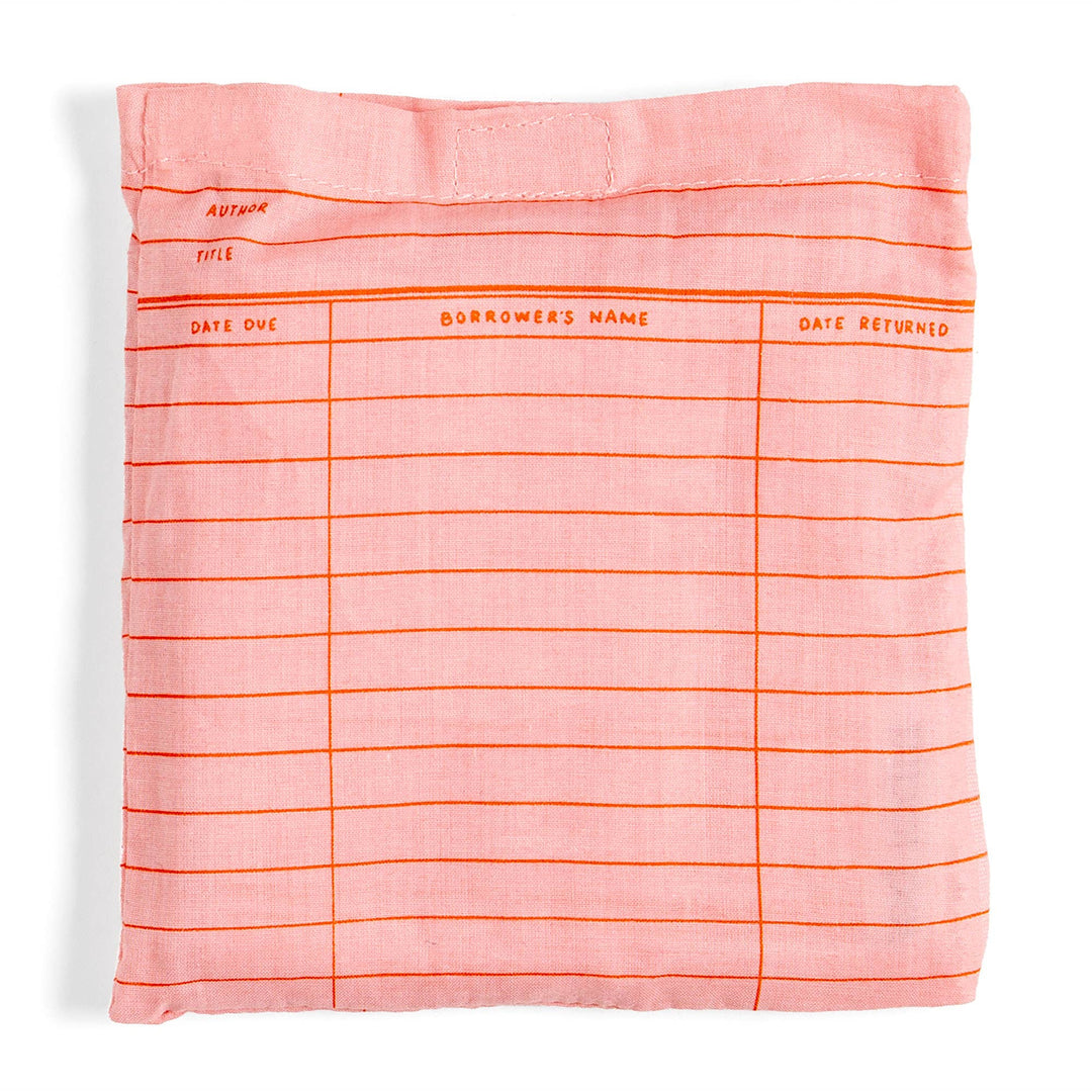 Pink fabric cover with orange text and lines on a white background