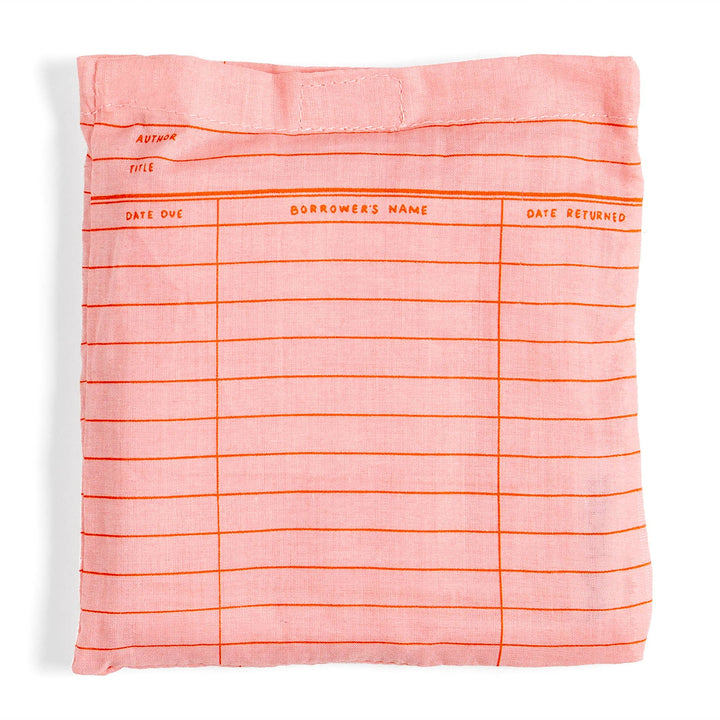 Pink fabric cover with orange text and lines on a white background