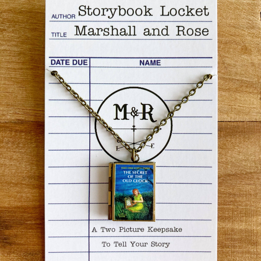 Storybook Locket with 'M&R' on a library card-style display