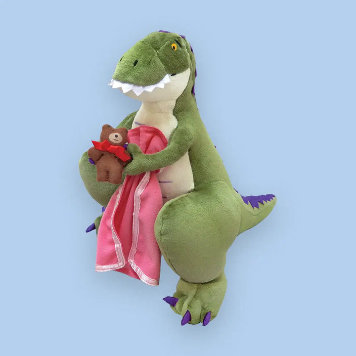 Plush toy dragon holding a pink blanket on a blue background