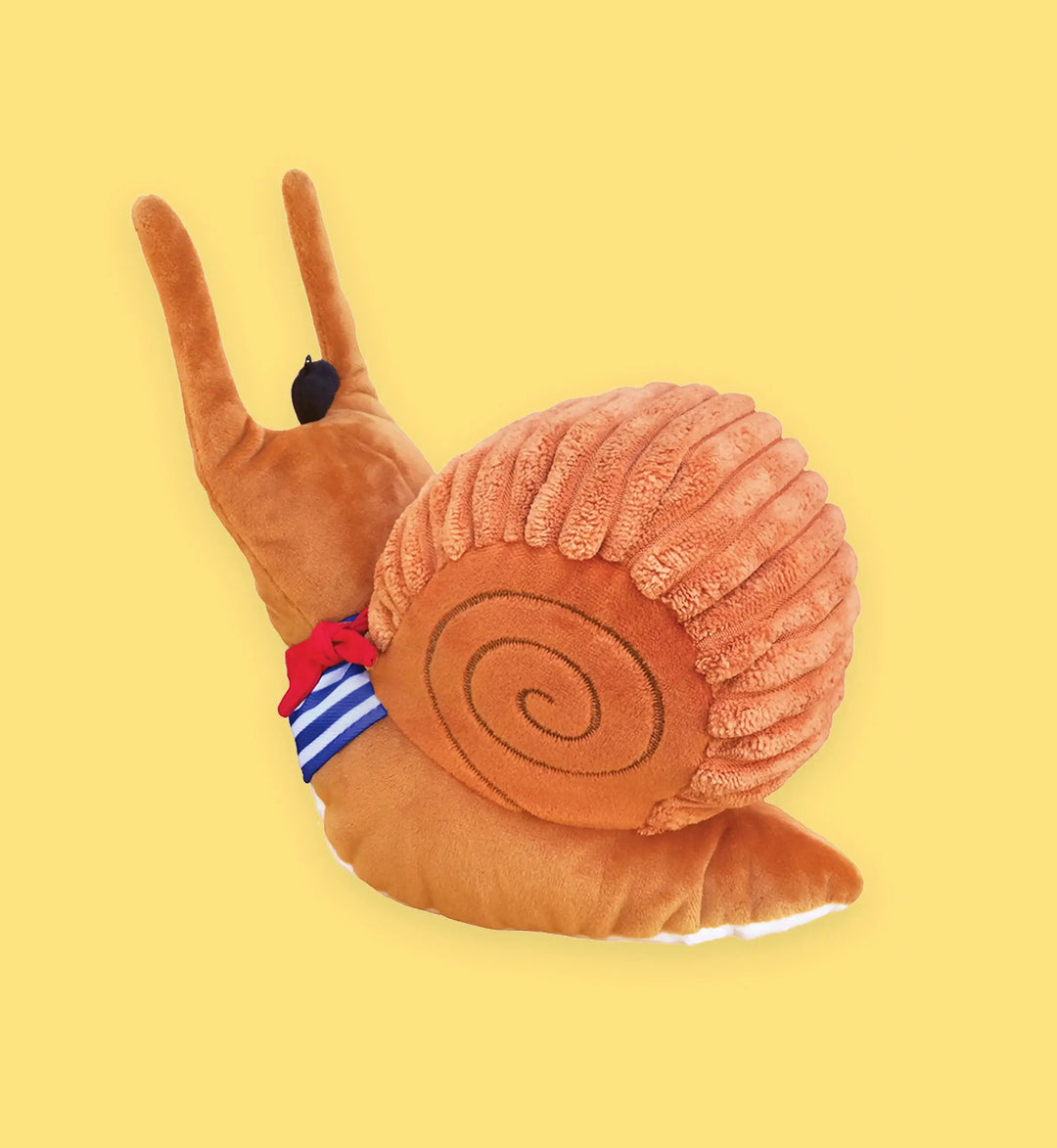 Plush snail toy with a striped flag on a yellow background