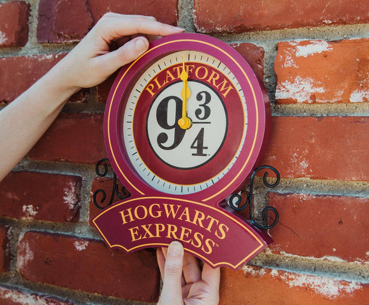 Wall clock with Platform 9 3/4 design against a brick wall