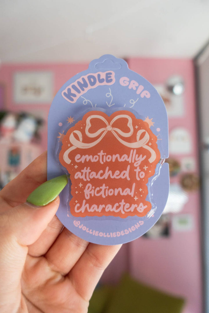 Hand holding a sticker with text &