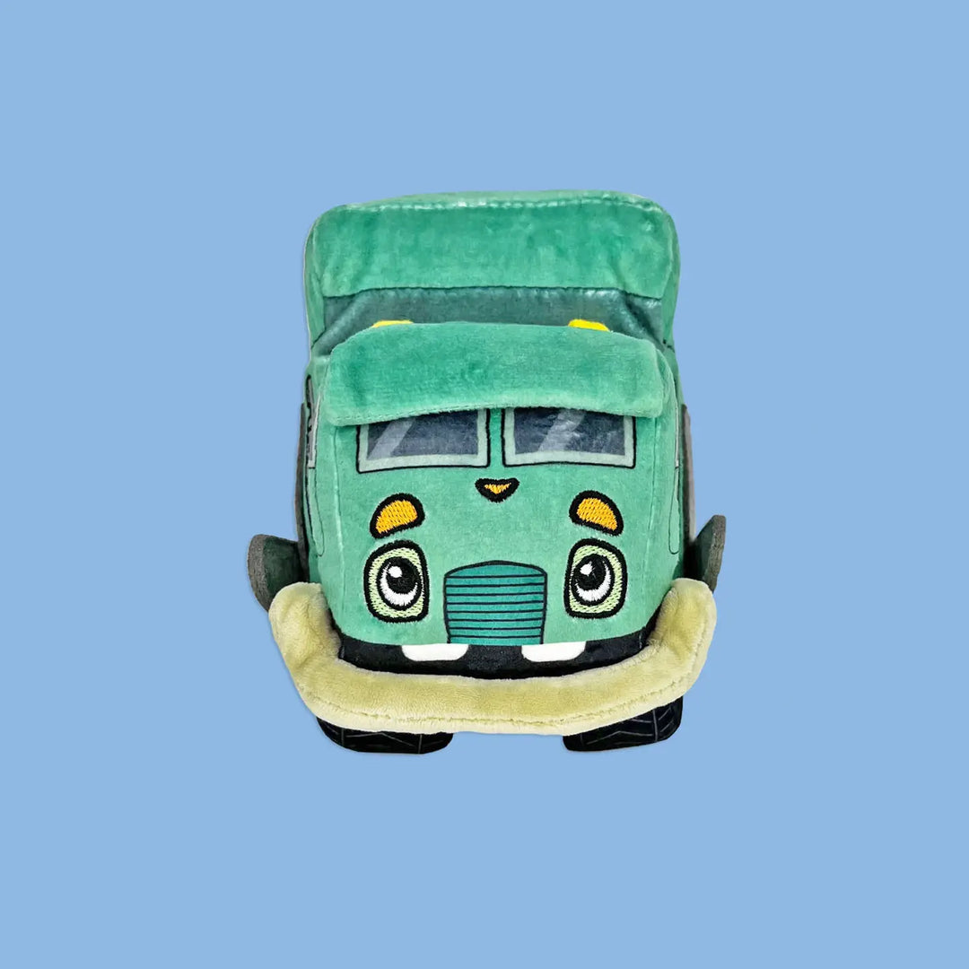 Green plush toy car with a smiling face on a blue background