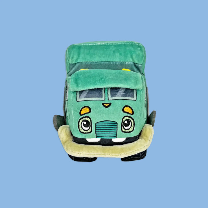 Green plush toy car with a smiling face on a blue background
