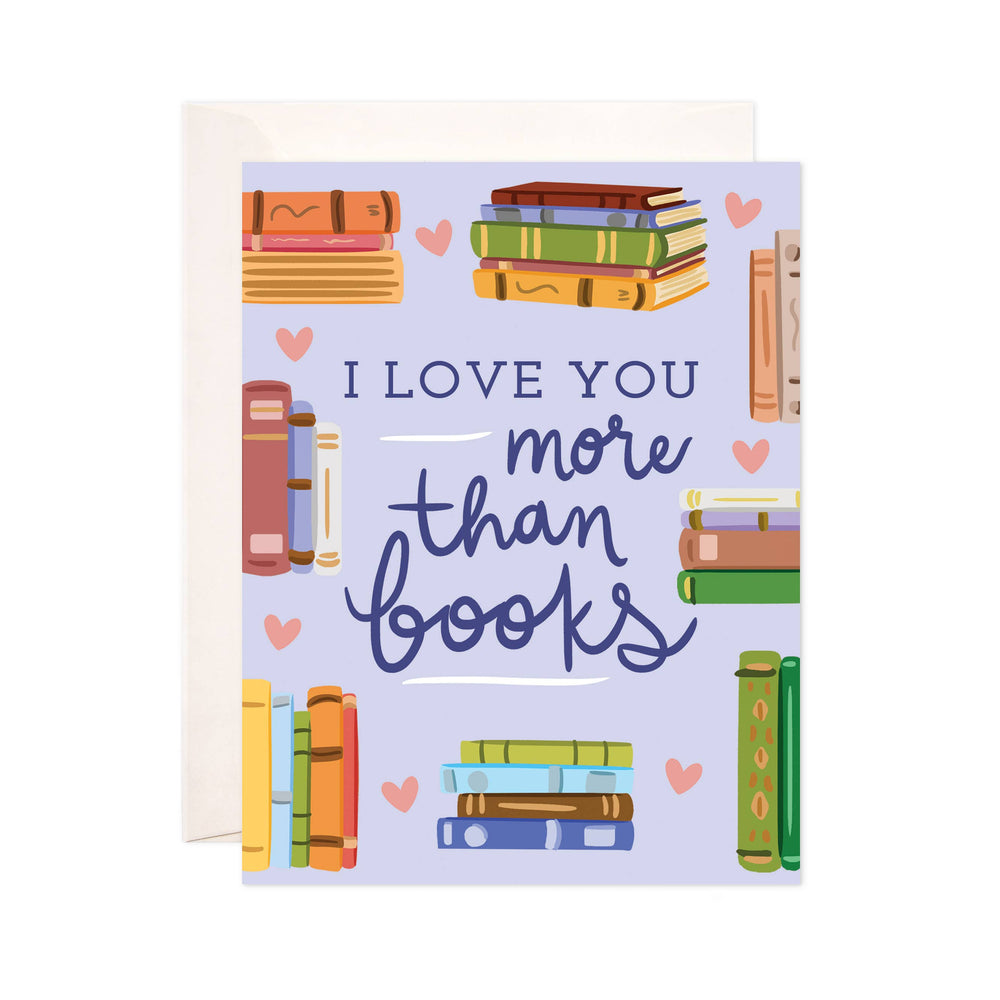 Greeting card with books and 'I love you more than books' text on a purple background