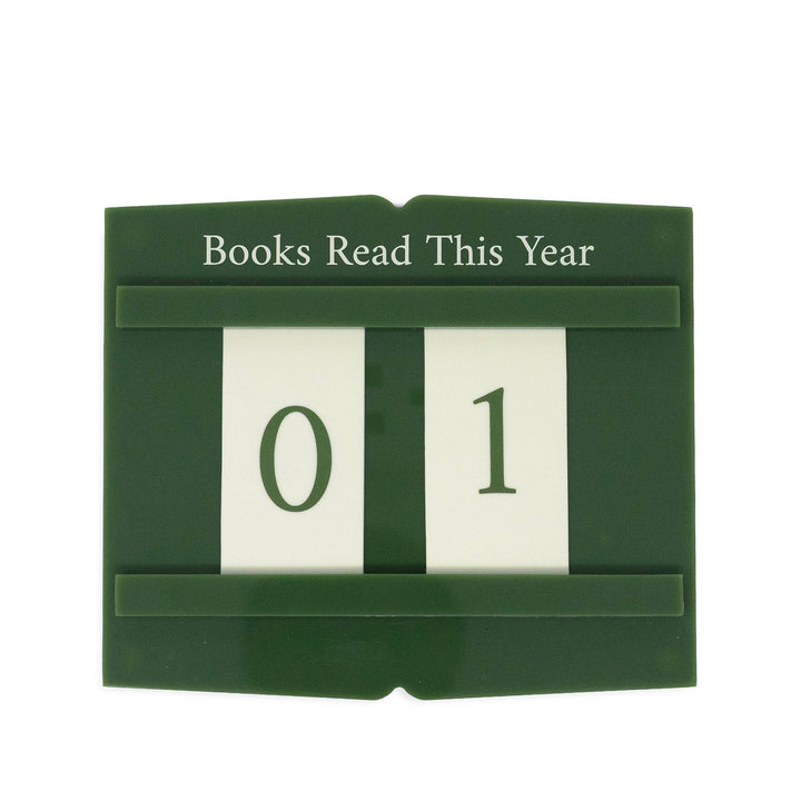 A dark green book-shaped calendar displaying &