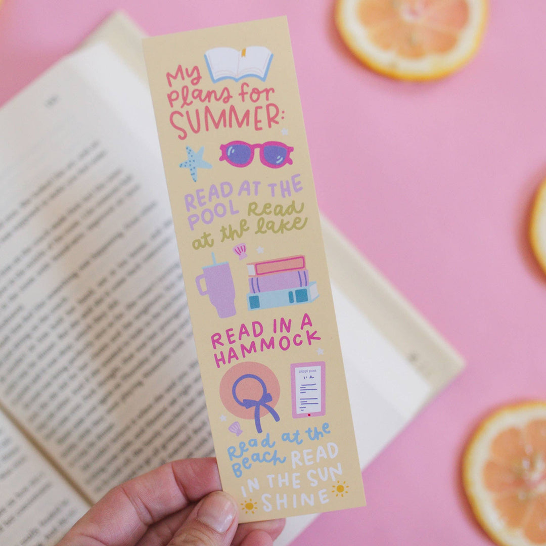 Bookmark with summer activities on a pink background with an open book and orange slices.
