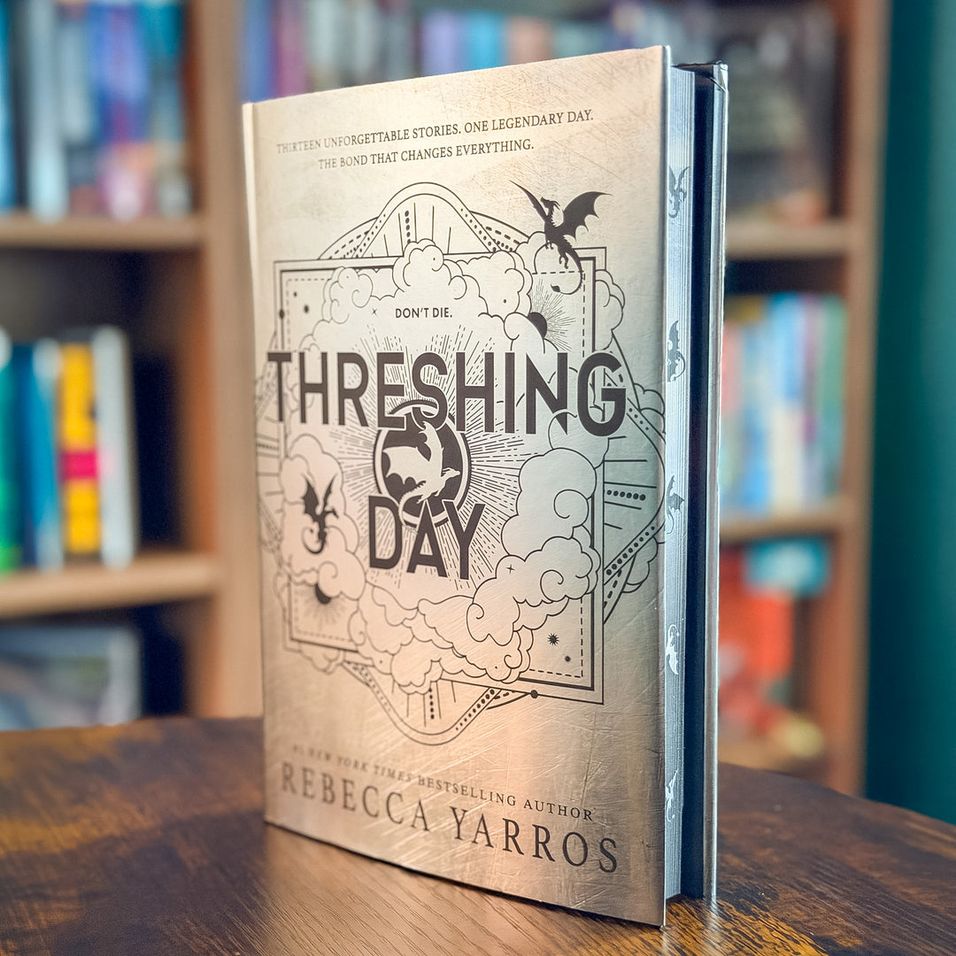 The front and spine of the book 'Threshing Day' by Rebecca Yarros, featuring a detailed black and white gothic illustration of a bird, clouds, and bats on a textured light gray background.