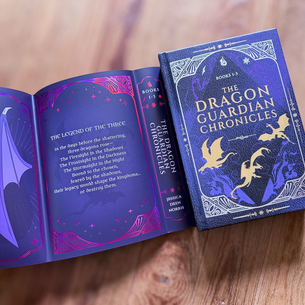 Open book titled 'The Dragon Guardian Chronicles' on a wooden surface