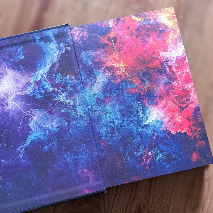 Colorful endpapers with abstract designs on a wooden surface