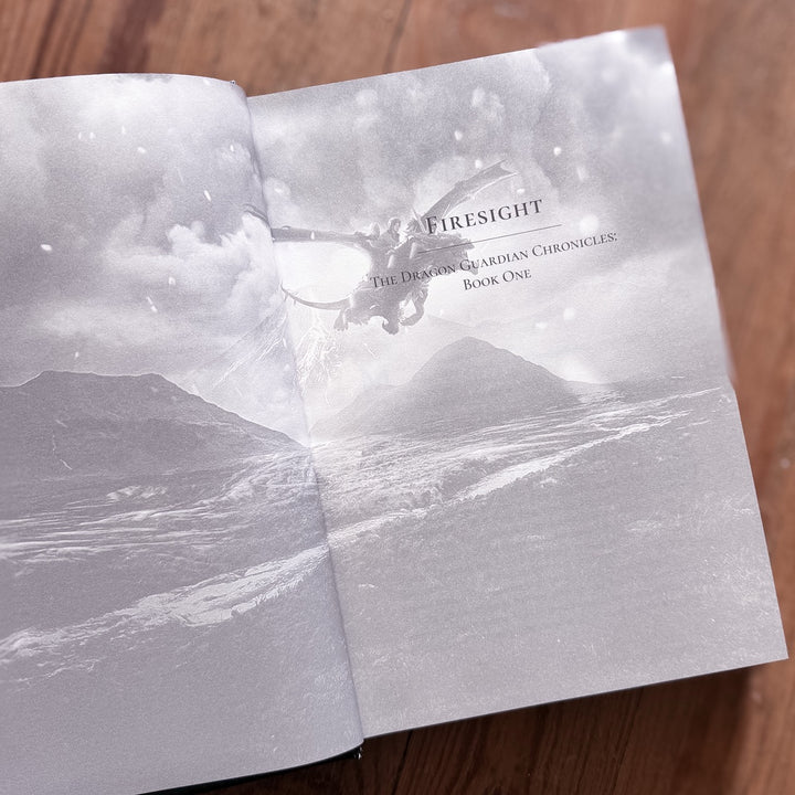 Open book with a volcanic landscape illustration and &