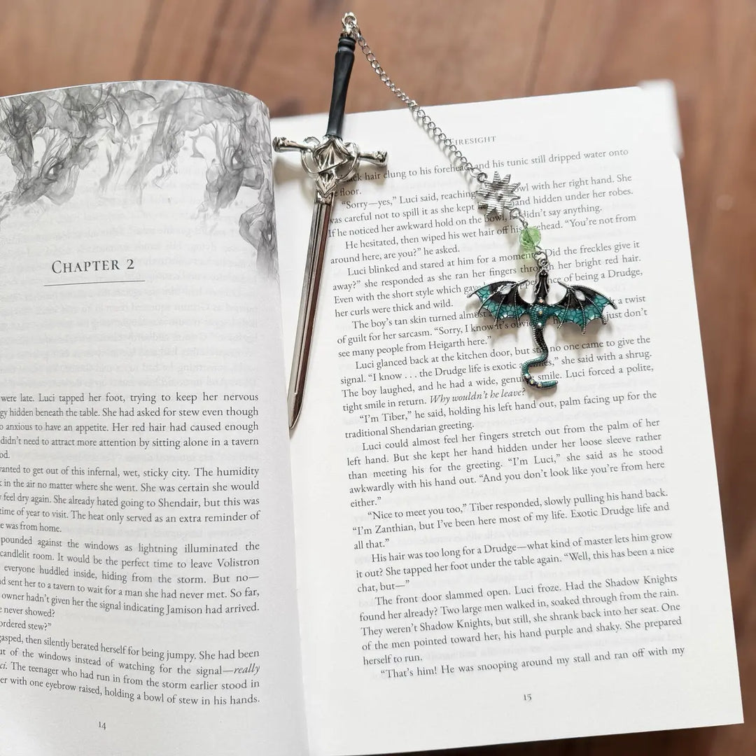 Decorative sword and shield bookmark on an open book