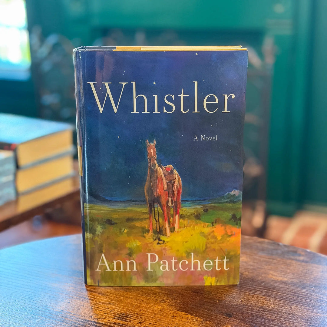 Book titled 'Whistler' by Ann Patchett with a horse illustration on a table.