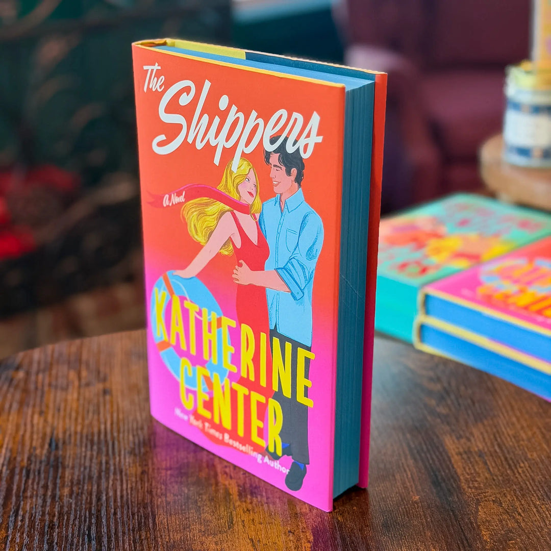 Book titled 'The Shippers' by Katherine Center on a wooden table with a blurred background