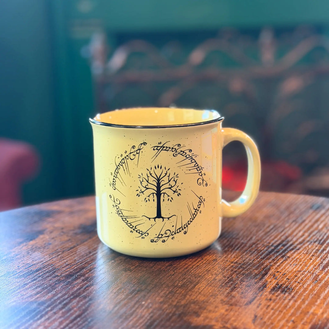 Yellow mug with tree design on a wooden table