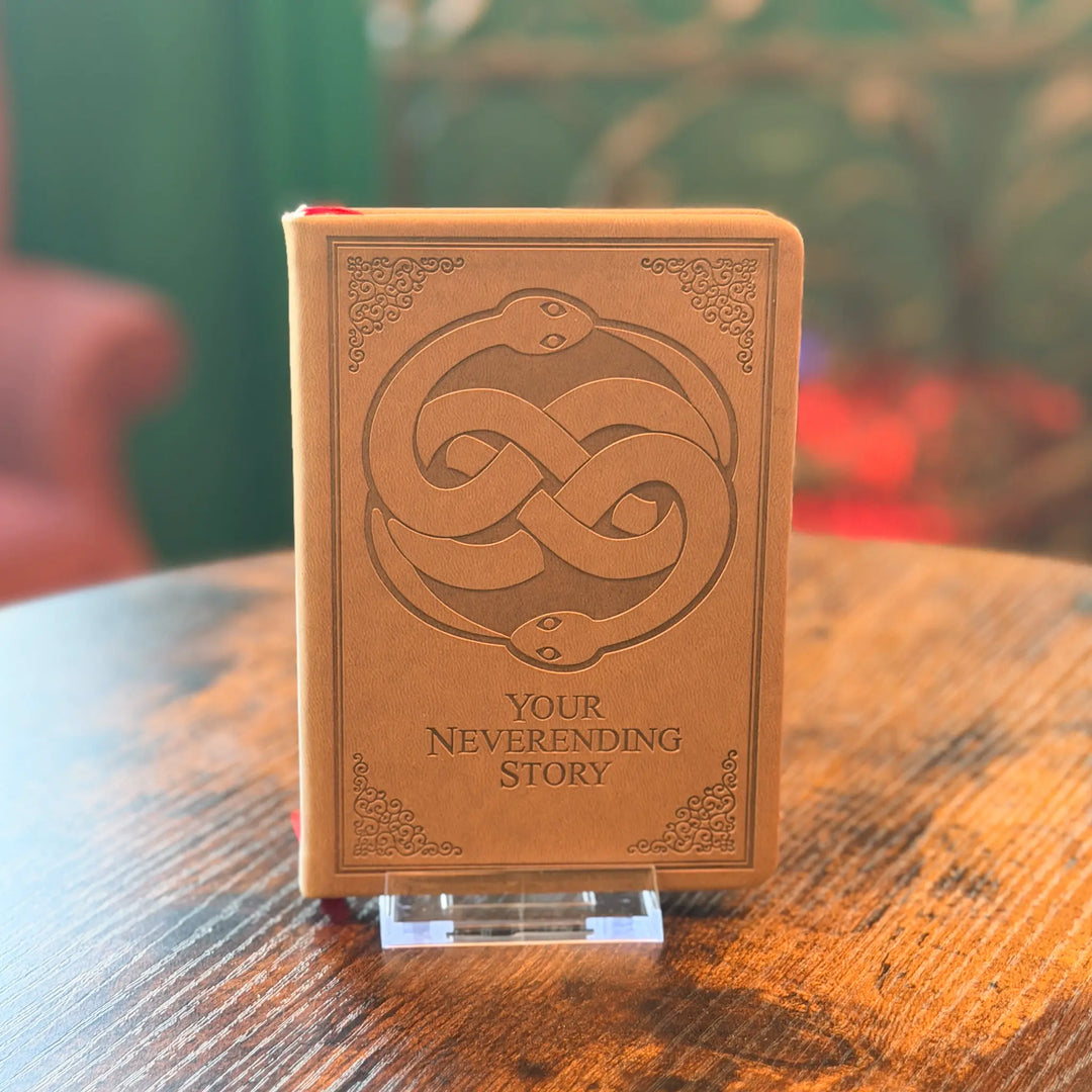 Brown book with snake design and &