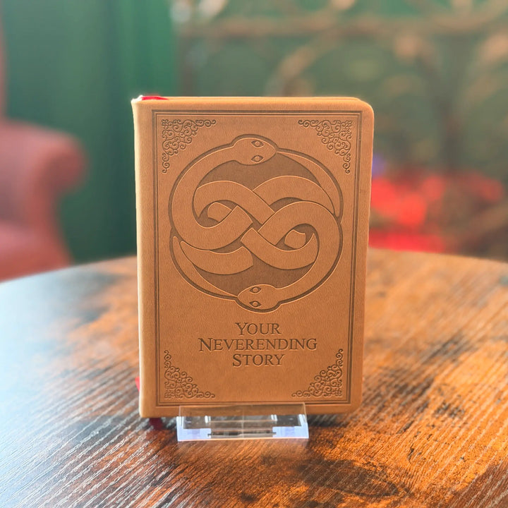 Brown book with snake design and &