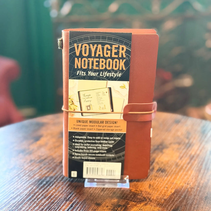 Voyager Notebook on a wooden surface with a blurred background