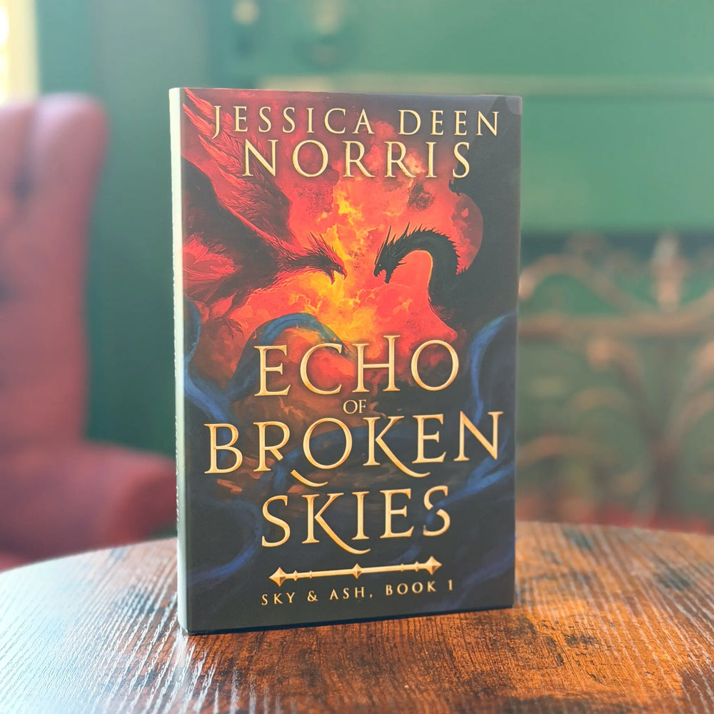 Book titled 'Echo of Broken Skies' by Jessica Deen Norris on a wooden surface with a blurred background.