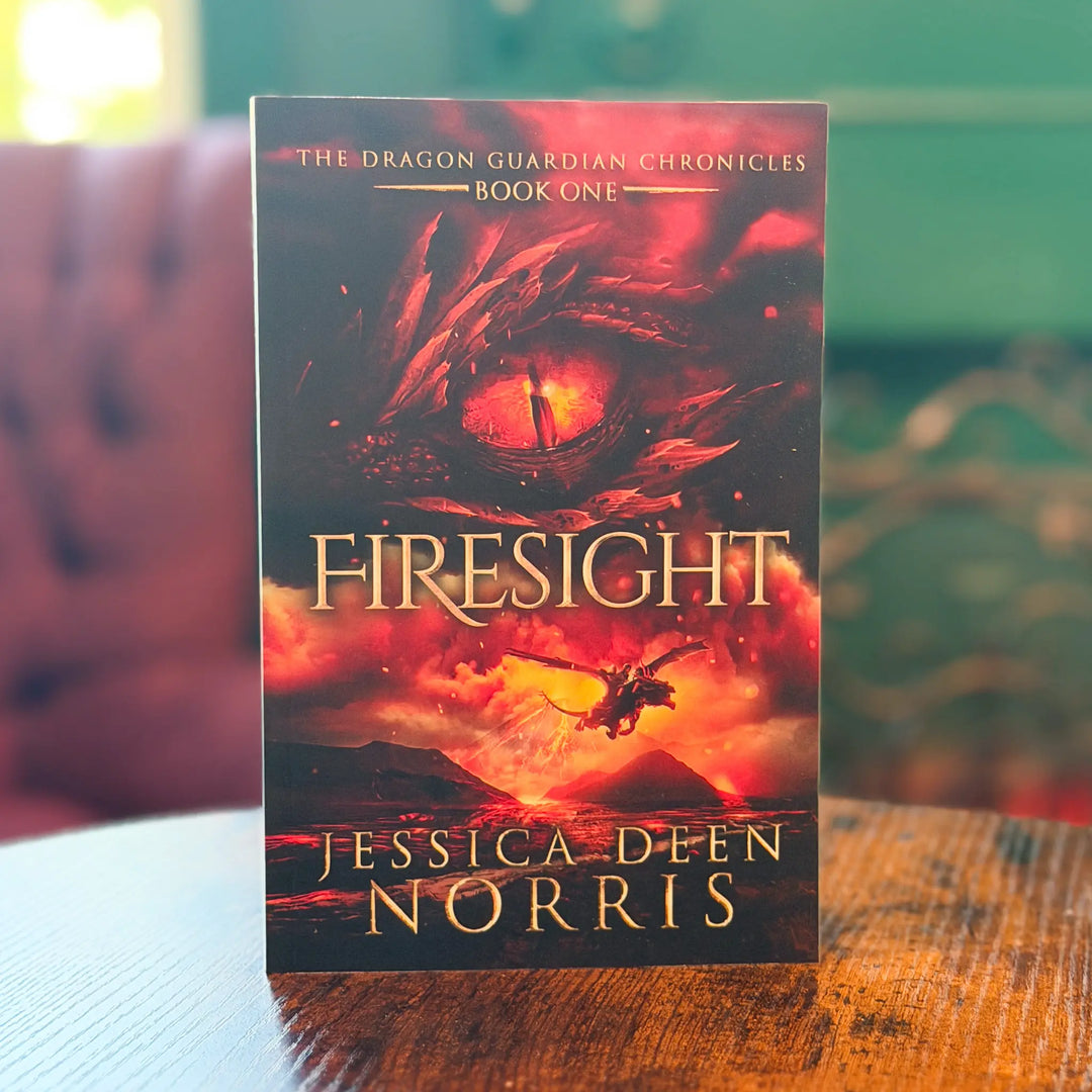 Book titled 'Firesight' by Jessica Deen Norris on a wooden surface with a blurred background