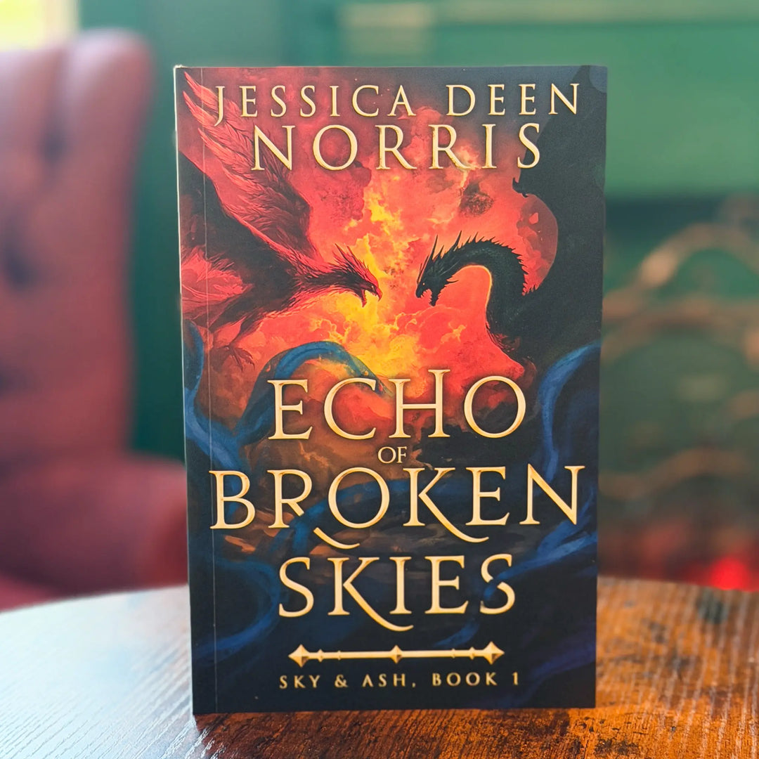 Book titled 'Echo of Broken Skies' by Jessica Deen Norris on a wooden surface with a blurred background.