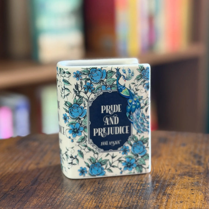 Decorative book-shaped candle with floral design and &