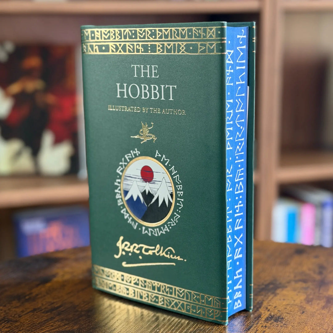 Book titled 'The Hobbit' with decorative cover on a wooden surface