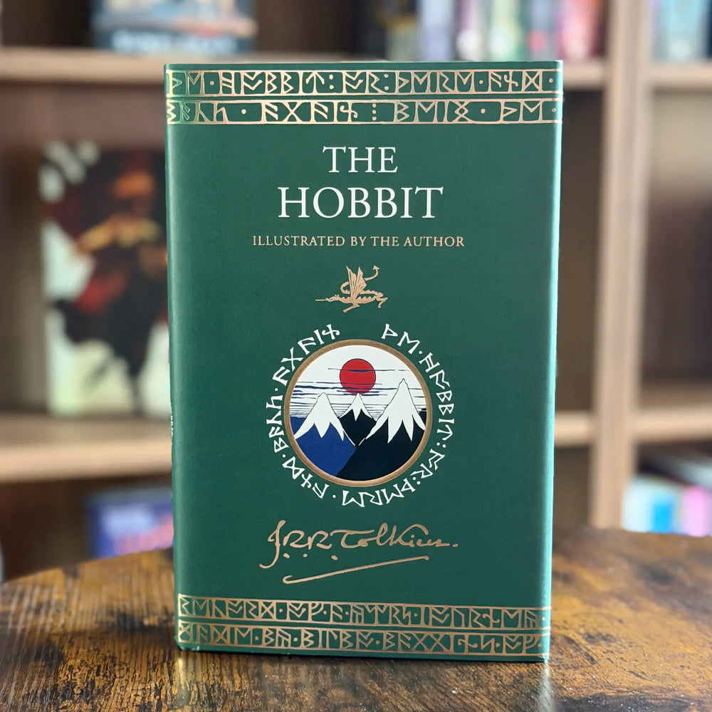 Book titled 'The Hobbit' with decorative cover on a wooden surface