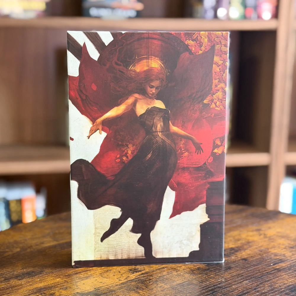 Decorative box with artistic design of a woman in a flowing dress on a wooden surface.